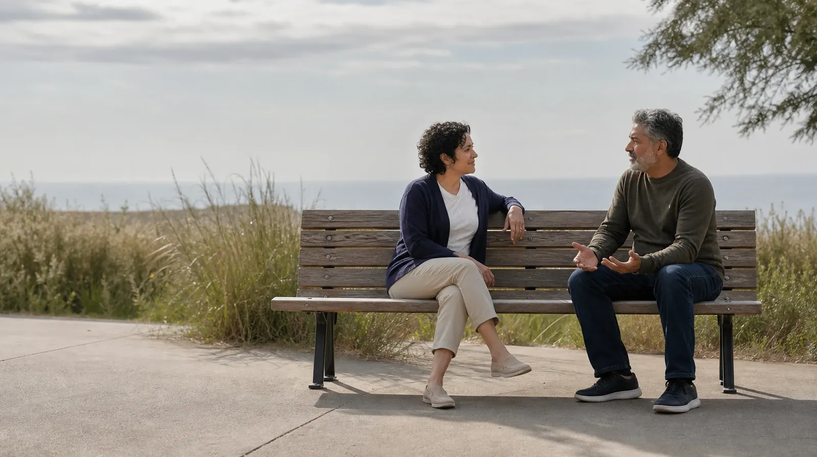 Starting a Treatment Conversation for Atlantis, FL Residents | Two adults sit on an outdoor bench and talk Two adults sit on an outdoor bench and talk · Starting a Treatment Conversation for Atlantis, FL Residents