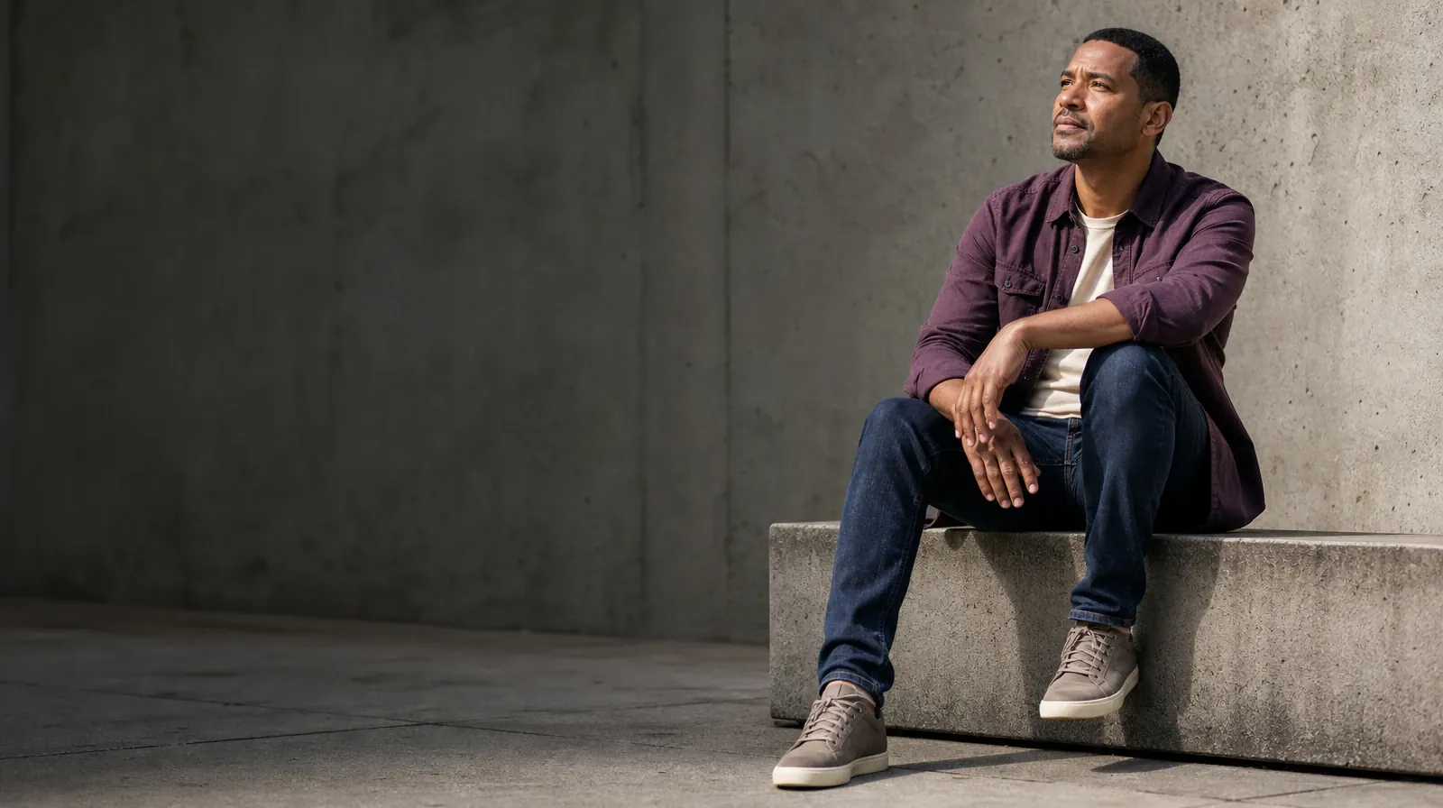 Addiction Treatment for Bal Harbour, FL Residents | An adult sits on a low concrete ledge with one knee raised and looks… An adult sits on a low concrete ledge with one knee raised and looks… · Addiction Treatment for Bal Harbour, FL Residents