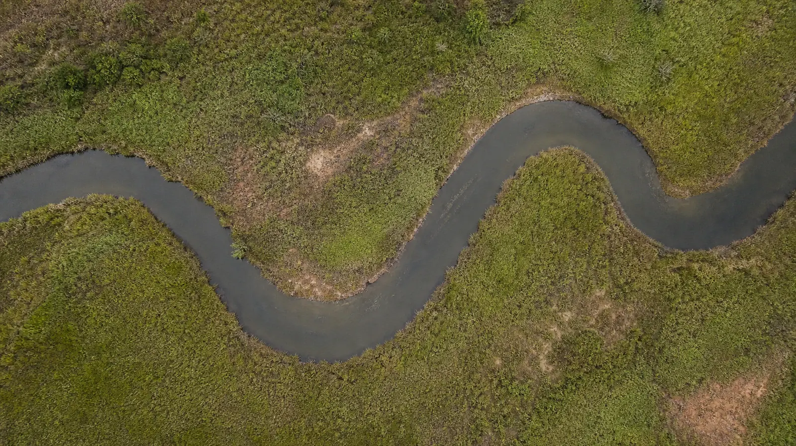 A narrow curving water channel passes through low green… · Residential Addiction Treatment for Bay Harbor Islands, FL