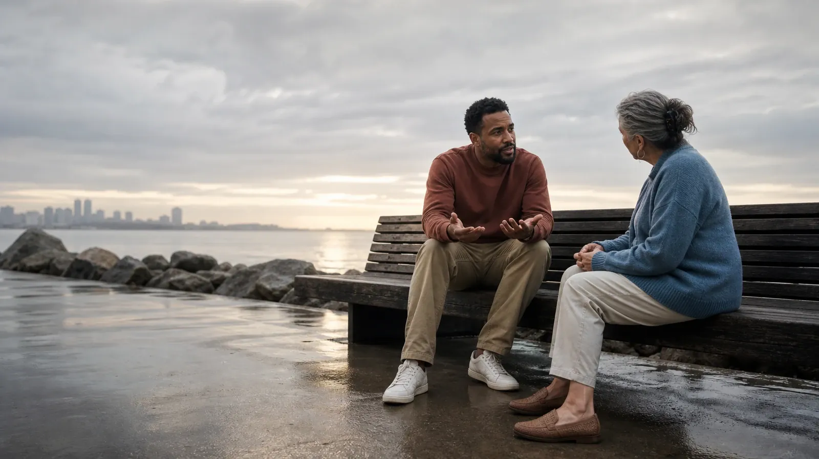 Two adults sit on an outdoor bench and talk · Supporting an Adult Loved One for Lake Clarke Shores, FL