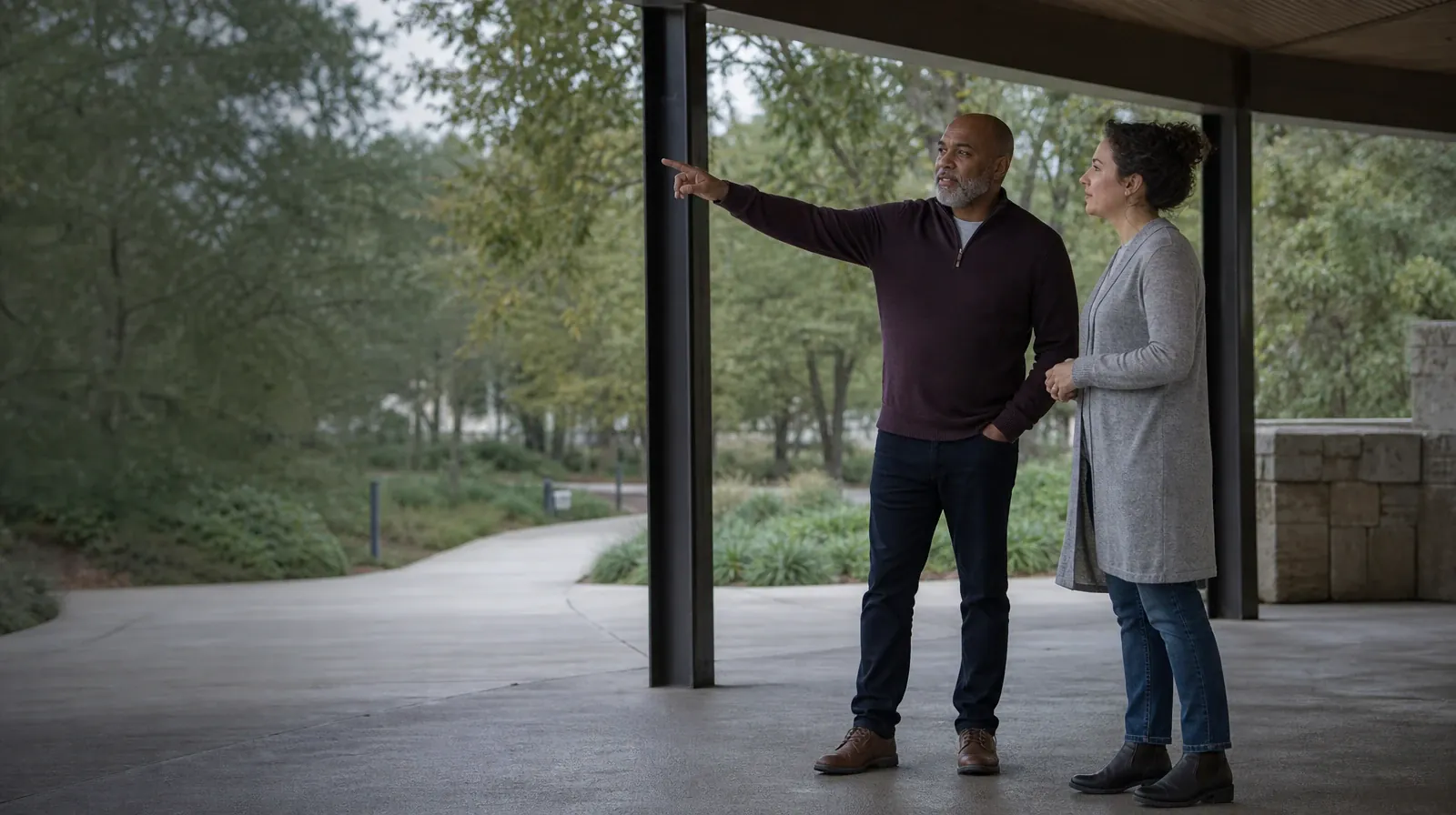 Two adults talk beneath a covered walkway · Treatment Cost Questions for Lake Park, FL Residents