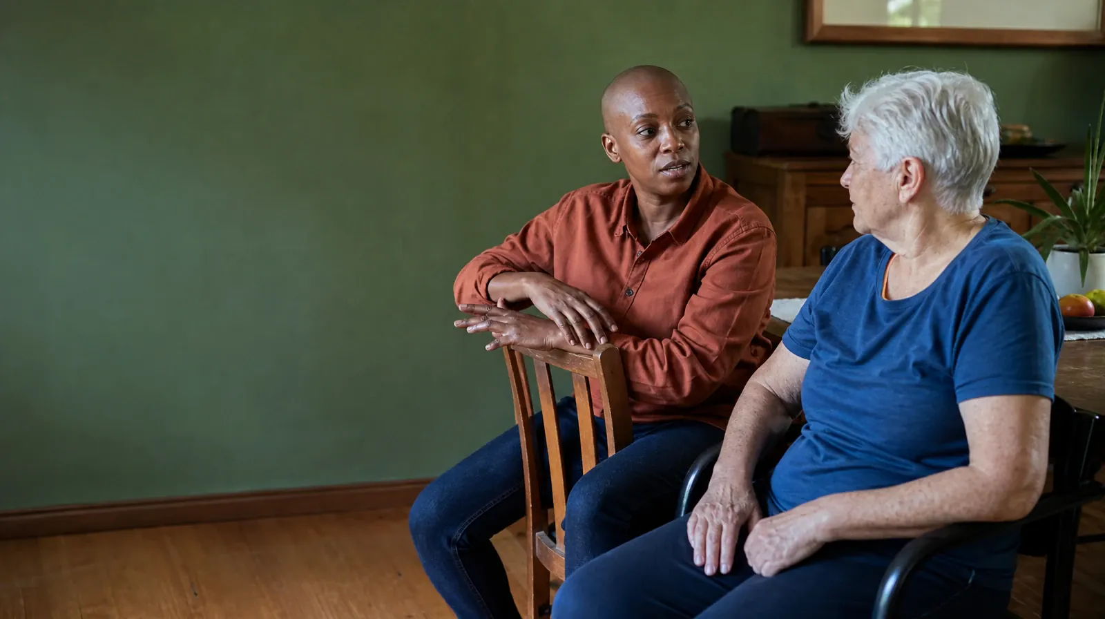 An adult sits backward on a wooden chair while another… · Fentanyl Addiction Treatment for Shenandoah, Miami, FL Residents