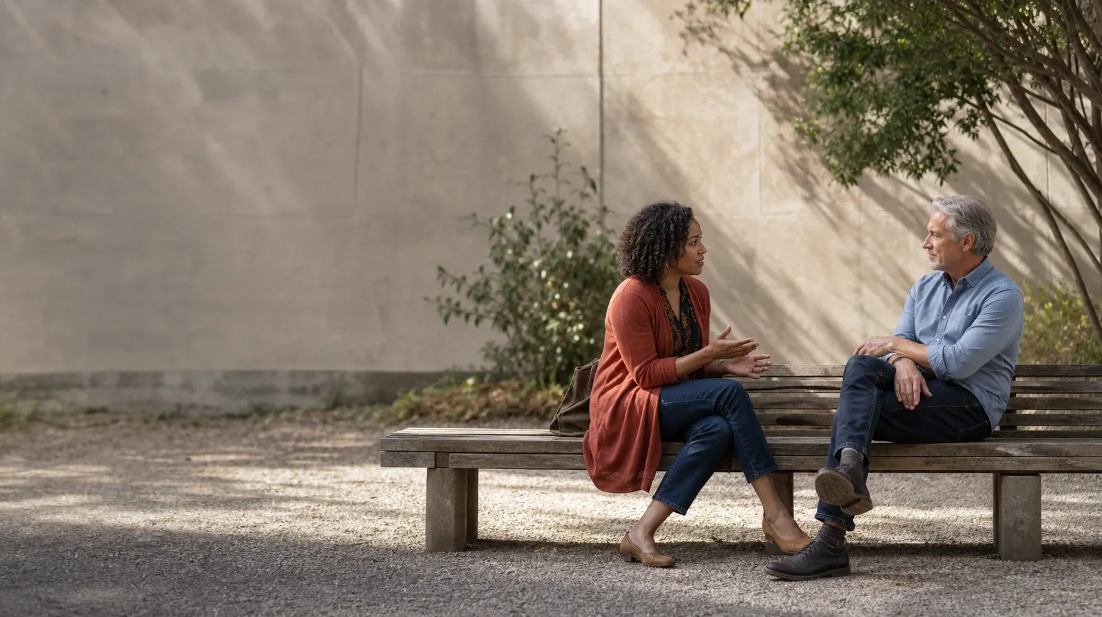 Two adults sit on an outdoor bench and talk · Addiction Treatment for West Flagler, Miami, FL Residents