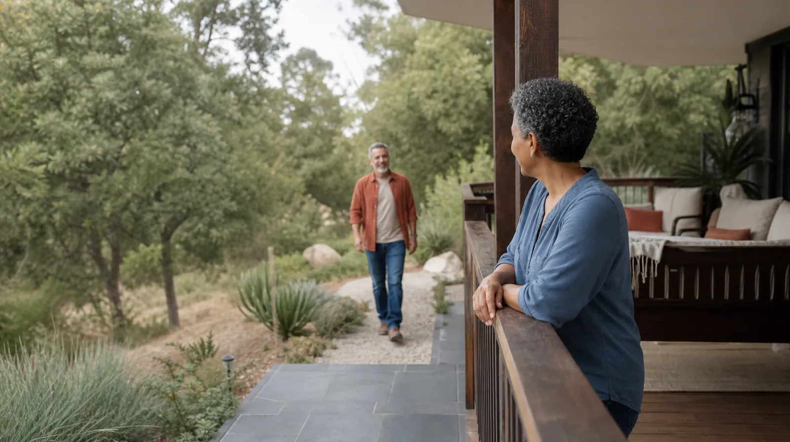 Two adults meet near a shaded porch · Supporting an Adult Loved One for North Palm Beach, FL Residents