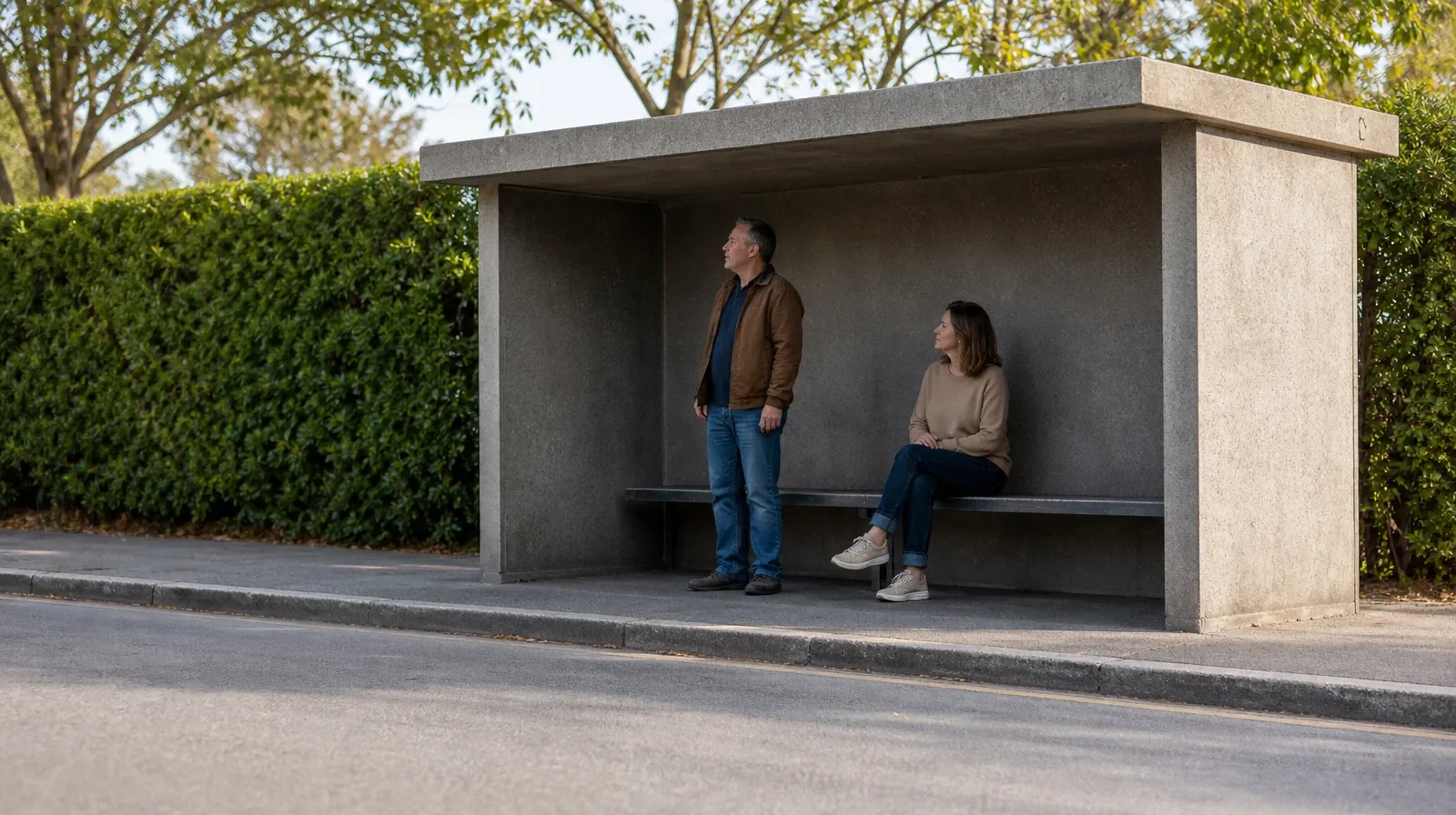 Two adults wait under a plain roadside shelter, with one seated… · Addiction Treatment for North Palm Beach, FL Residents