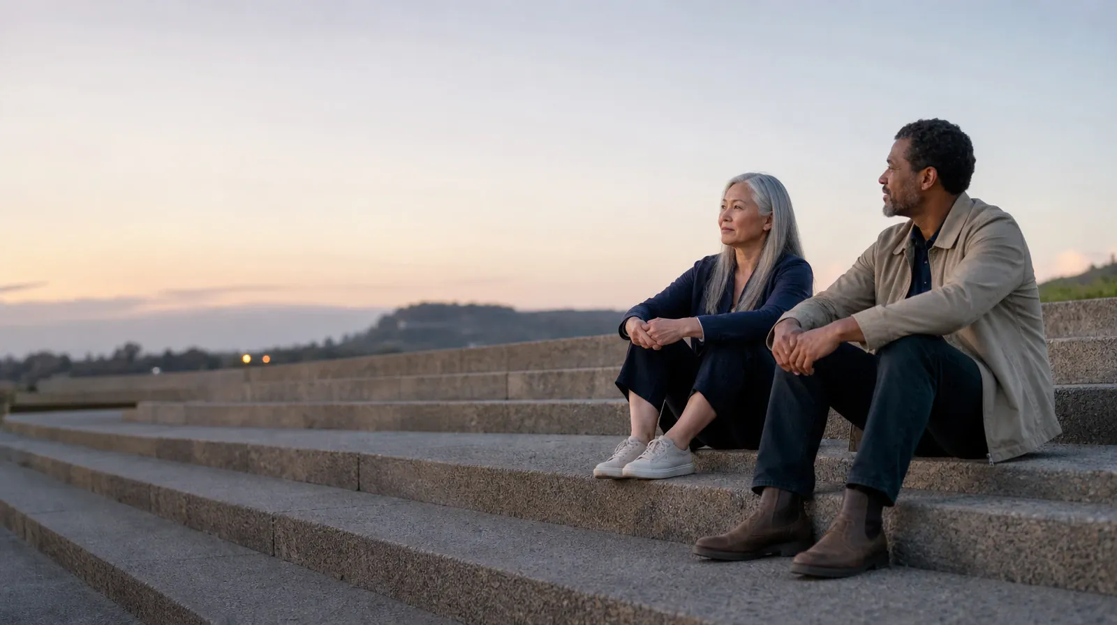 Two adults talk while seated on broad outdoor steps · Treatment Cost Questions for Palm Springs, FL Residents