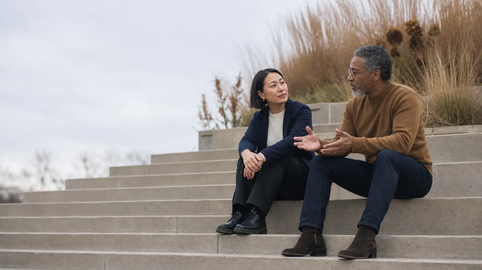 Language and Accessibility Questions for Plantation, FL Residents | Two adults talk while seated on broad outdoor steps Two adults talk while seated on broad outdoor steps · Language and Accessibility Questions for Plantation, FL Residents