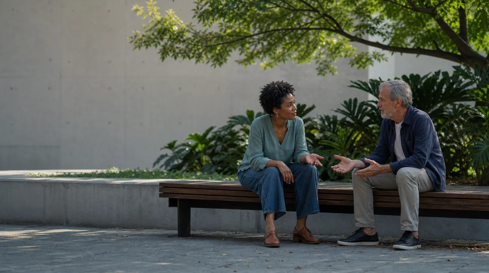 Two adults sit on an outdoor bench and talk · Language and Accessibility Questions for Saddlebunch Keys, FL