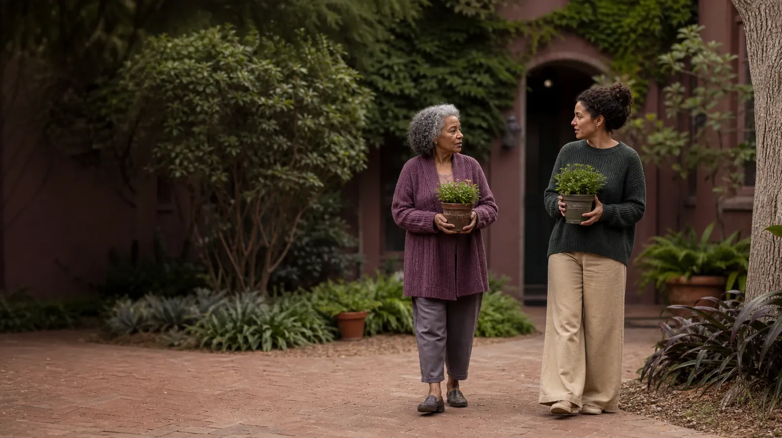 Two adults pause with small plants in a courtyard · Supporting an Adult Loved One for South Miami, FL Residents