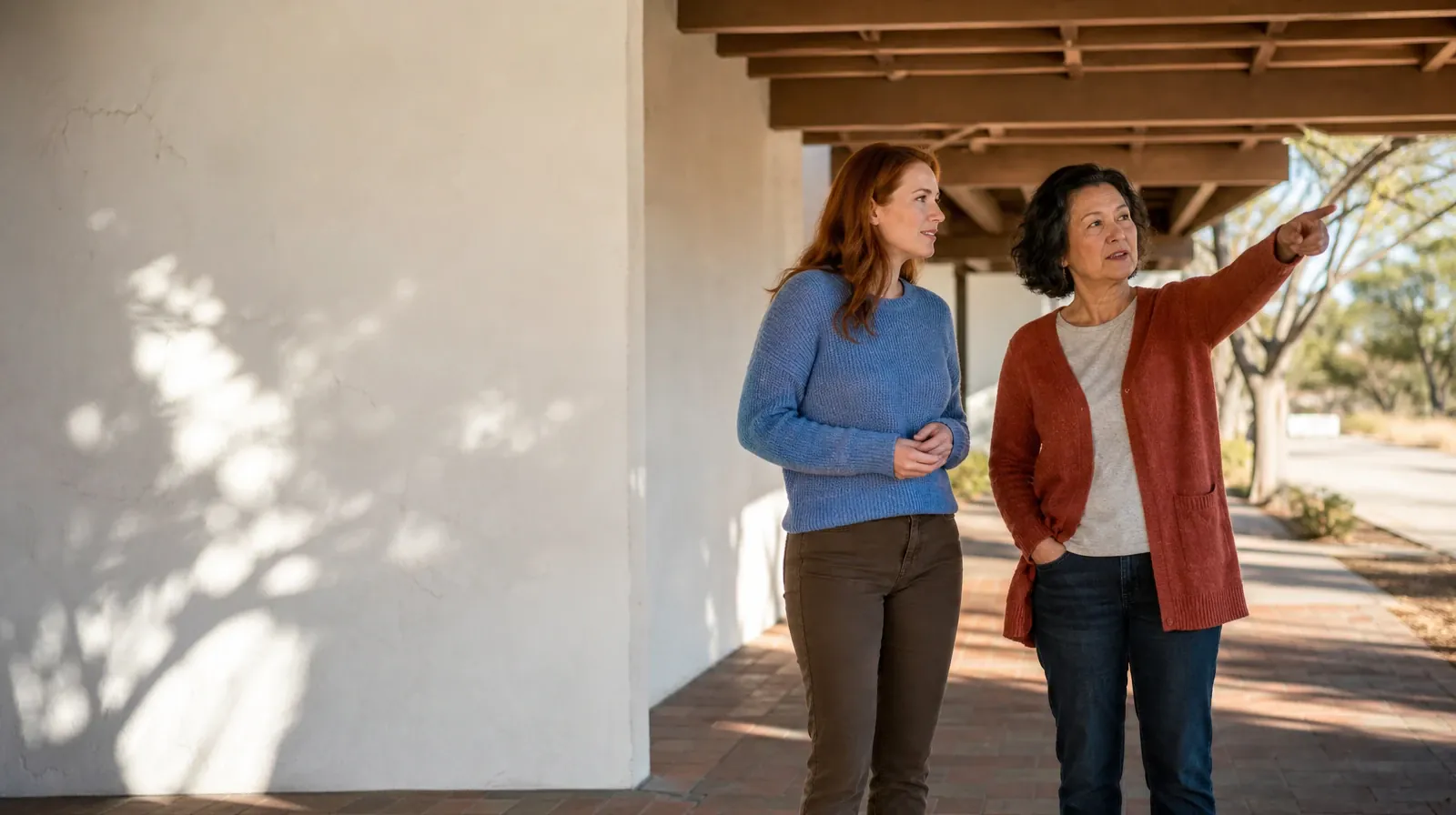 Two adults talk beneath a covered walkway · Supporting an Adult Loved One for Stock Island, FL Residents