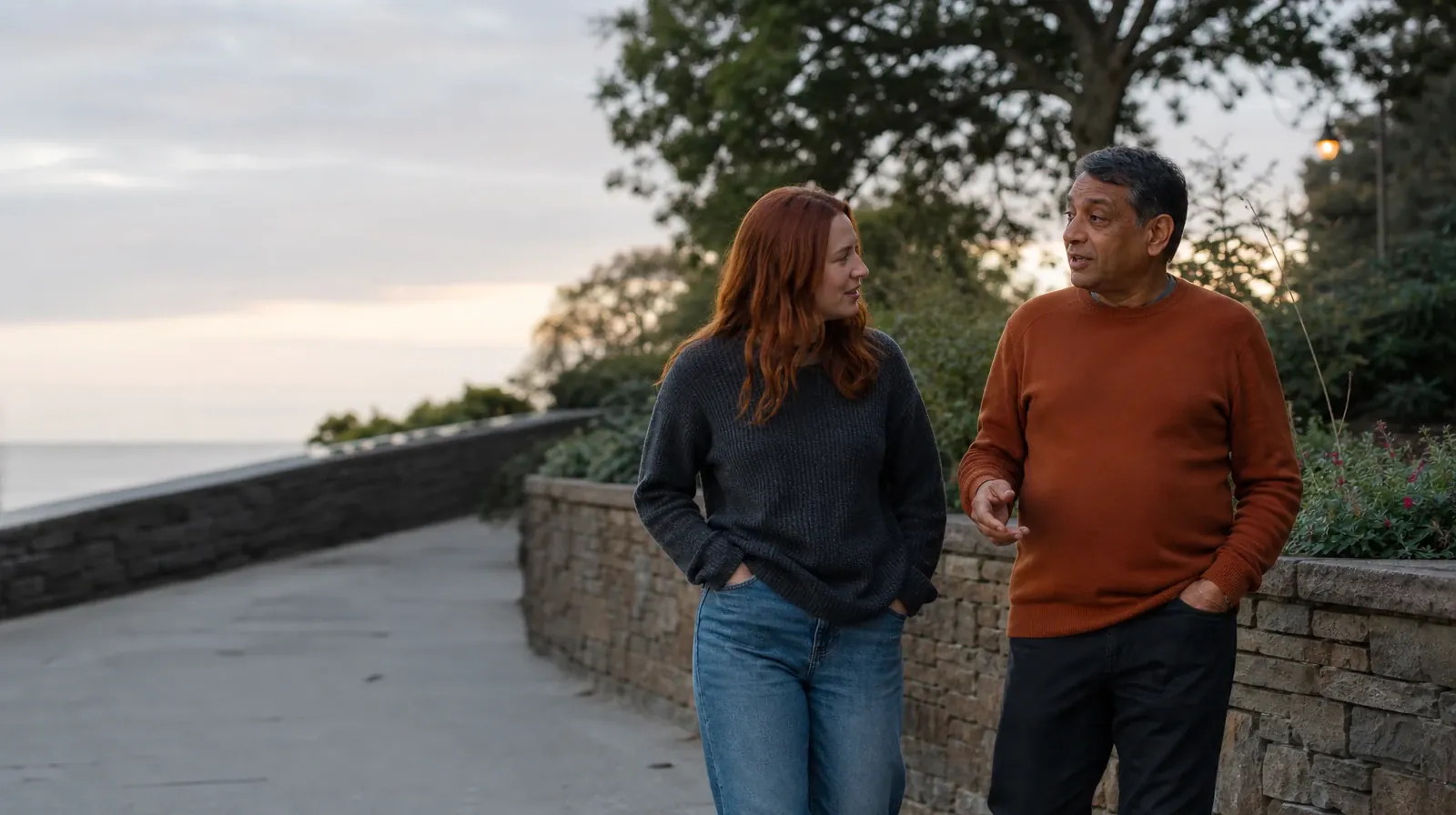 Two adults walk and talk beside a garden wall · Language and Accessibility Questions for Wellington, FL Residents