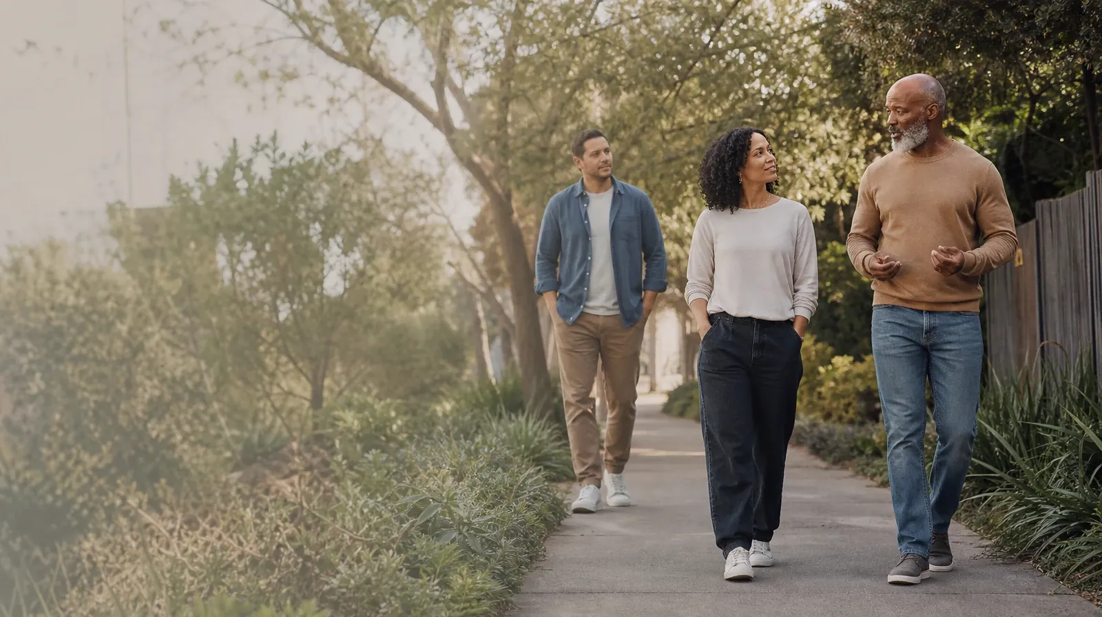 Holidays and Boundaries Around Hallucinogens Use in South Florida | Three adults walk and talk on an unmarked neighborhood… Three adults walk and talk on an unmarked neighborhood… · Holidays and Boundaries Around Hallucinogens Use in South Florida