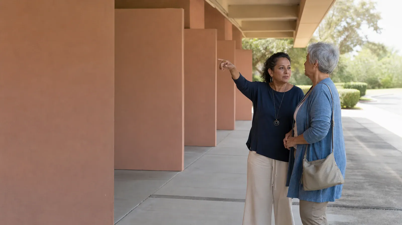 Two adults talk beneath a covered walkway · Keeping Appointments During Recovery From Lunesta Use