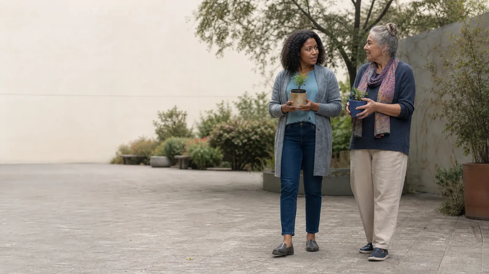 Family Conversations After Treatment for MDMA Use | Two adults pause with small plants in a courtyard Two adults pause with small plants in a courtyard · Family Conversations After Treatment for MDMA Use