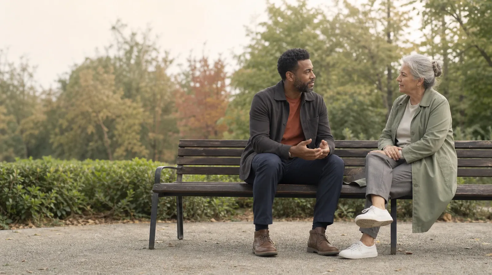 Two adults sit on an outdoor bench and talk · Reviewing Methamphetamine Care Recommendations