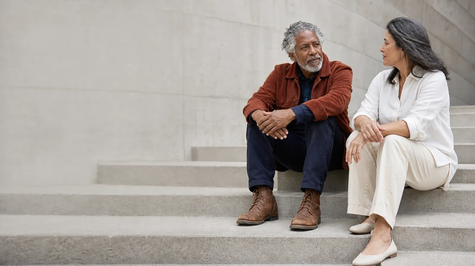 Family Conversations After Treatment for Opioids Use | Two adults talk while seated on broad outdoor steps Two adults talk while seated on broad outdoor steps · Family Conversations After Treatment for Opioids Use