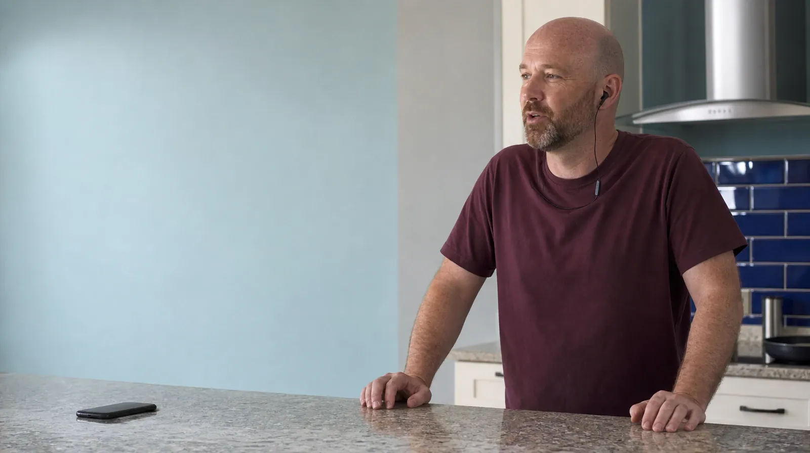 Asking for an Assessment for Alcohol Use in South Florida | An adult stands at a home counter and speaks using a single… An adult stands at a home counter and speaks using a single… · Asking for an Assessment for Alcohol Use in South Florida