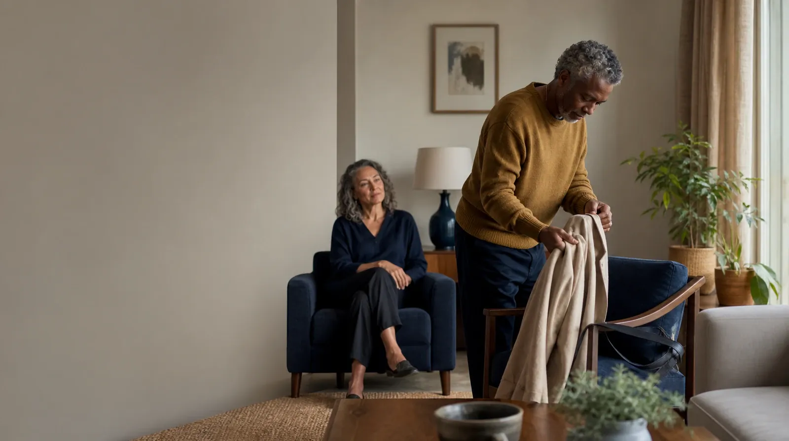 An adult folds a jacket while talking with someone nearby · Talking With Your Prescriber About Ativan Use in South Florida
