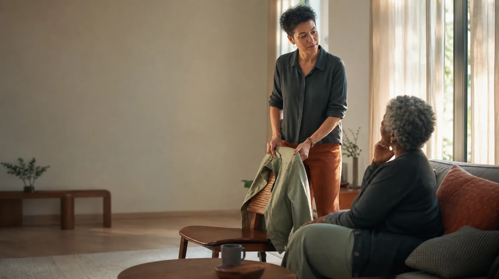 An adult folds a jacket while talking with someone nearby · When Other Substances Are Used With Ativan Use in South Florida