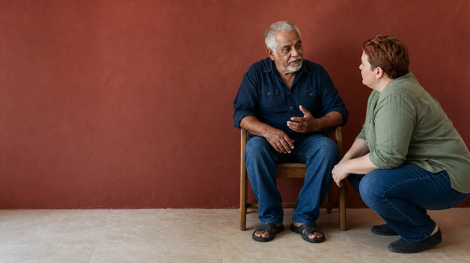 An adult crouches at the eye level of another adult speaking from a low… · Gabapentin Addiction Treatment in Miramar, FL