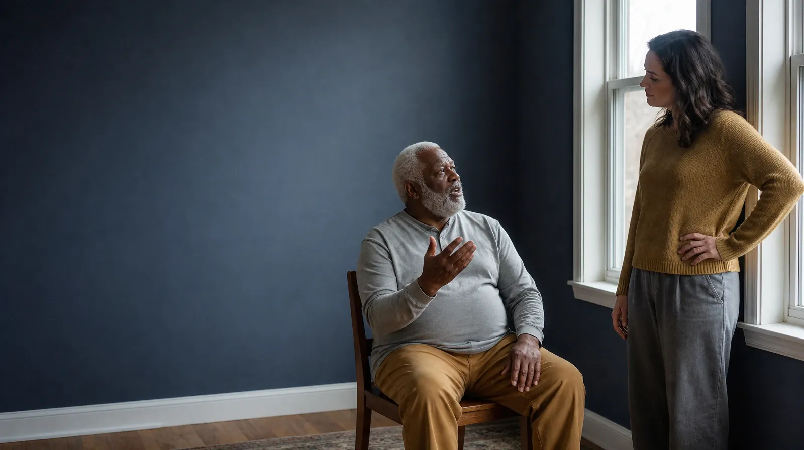 Hallucinogens Addiction Treatment in Miramar, FL | A seated adult speaks to another adult standing nearby beside a low home… A seated adult speaks to another adult standing nearby beside a low home… · Hallucinogens Addiction Treatment in Miramar, FL
