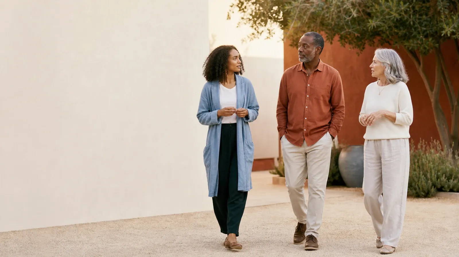 Three adults walk and talk through a courtyard · Work and Treatment Planning for Hydrocodone Use in South Florida