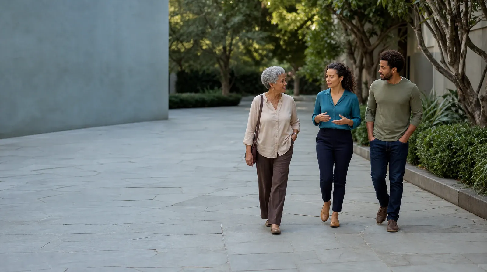 Three adults walk and talk through a courtyard · Work and Treatment Planning for Prescription Drug Use