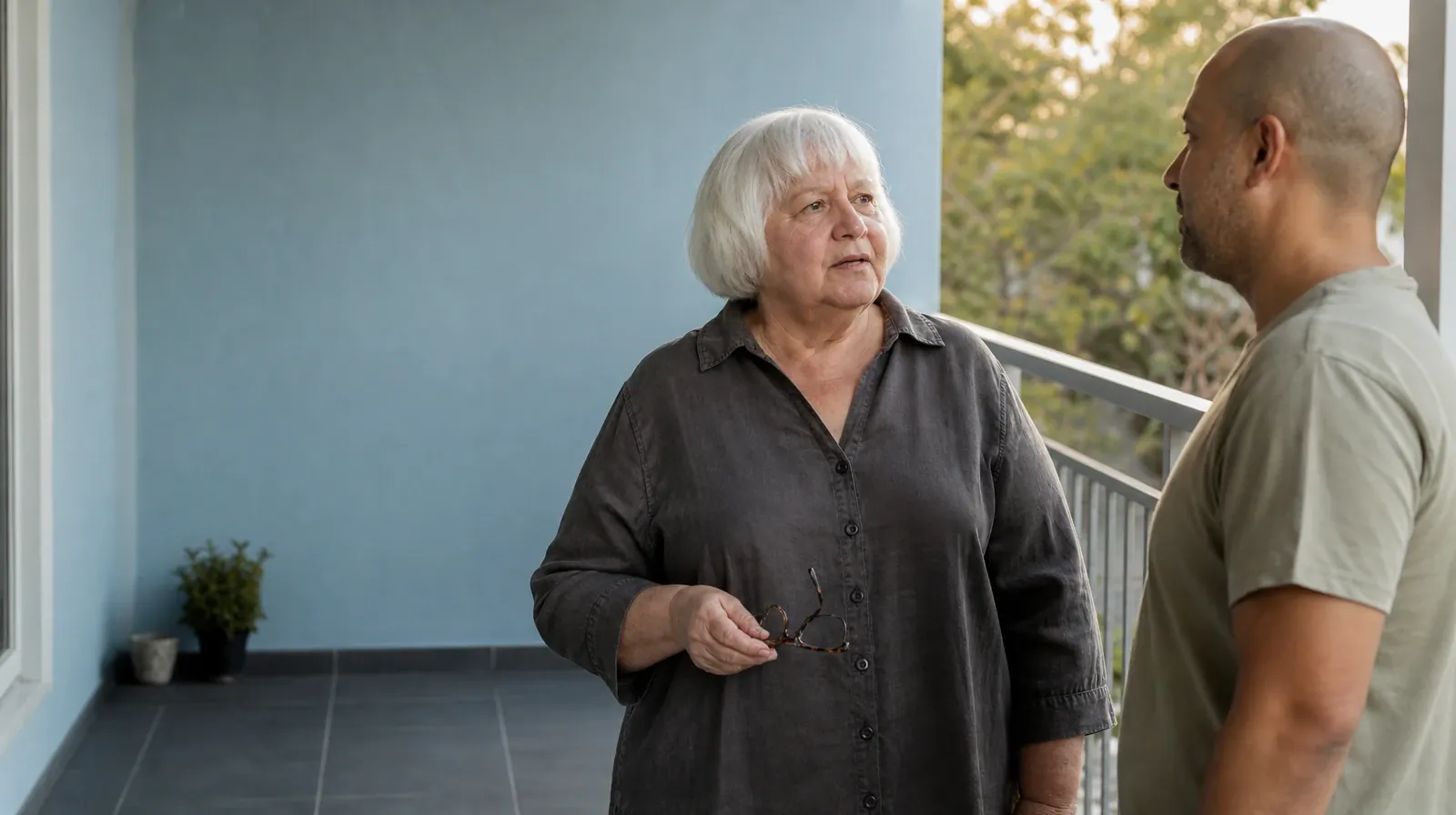 An older adult holds reading glasses at her waist while… · Practitioner Questions About Cognitive Behavioral Therapy