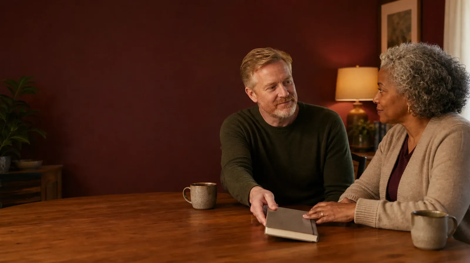 Privacy and Consent in DBT | An adult slides a closed journal across a home table toward another adult An adult slides a closed journal across a home table toward another adult · Privacy and Consent in DBT
