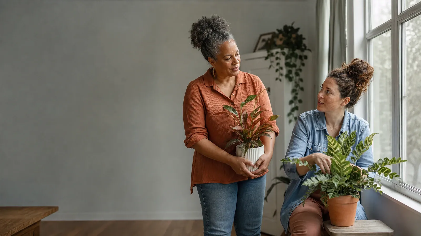 Two adults tend houseplants and talk · When an Approach Does Not Fit: Family support in South Florida