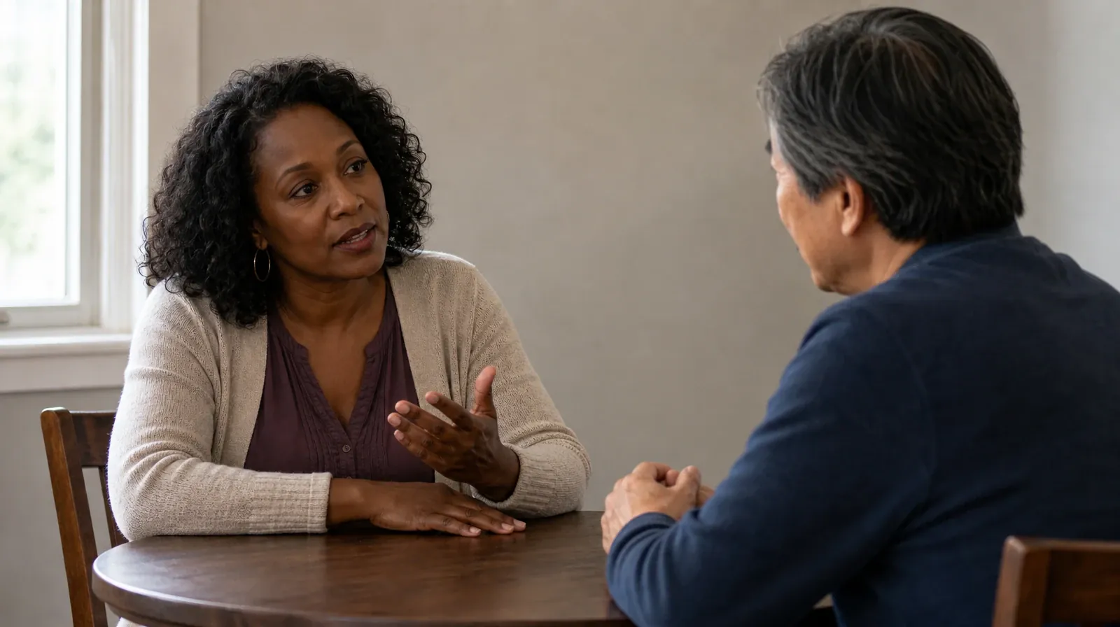 Medication education for Addiction Treatment in Miramar, FL | Adult asks a question across a small round table while… Adult asks a question across a small round table while… · Medication education for Addiction Treatment in Miramar, FL