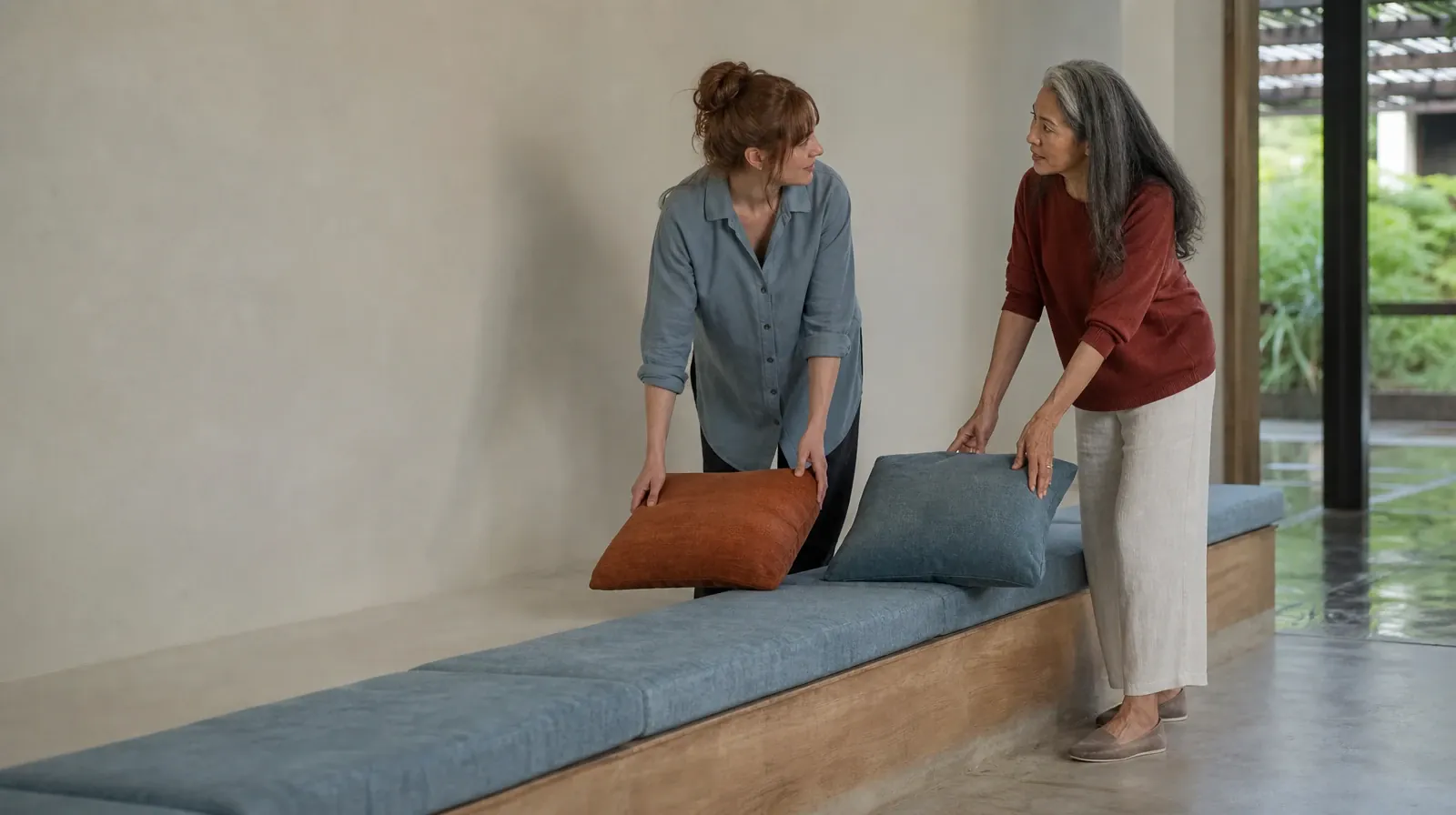 Daily Routines and Motivational Enhancement Therapy | Two adults pause while arranging cushions on a bench Two adults pause while arranging cushions on a bench · Daily Routines and Motivational Enhancement Therapy
