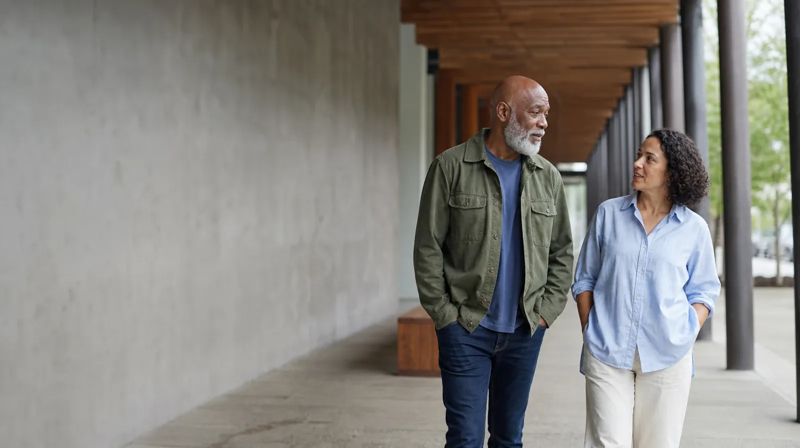 A Support Network for Parents Seeking Care | Two adults walk and talk beneath a covered arcade Two adults walk and talk beneath a covered arcade · A Support Network for Parents Seeking Care